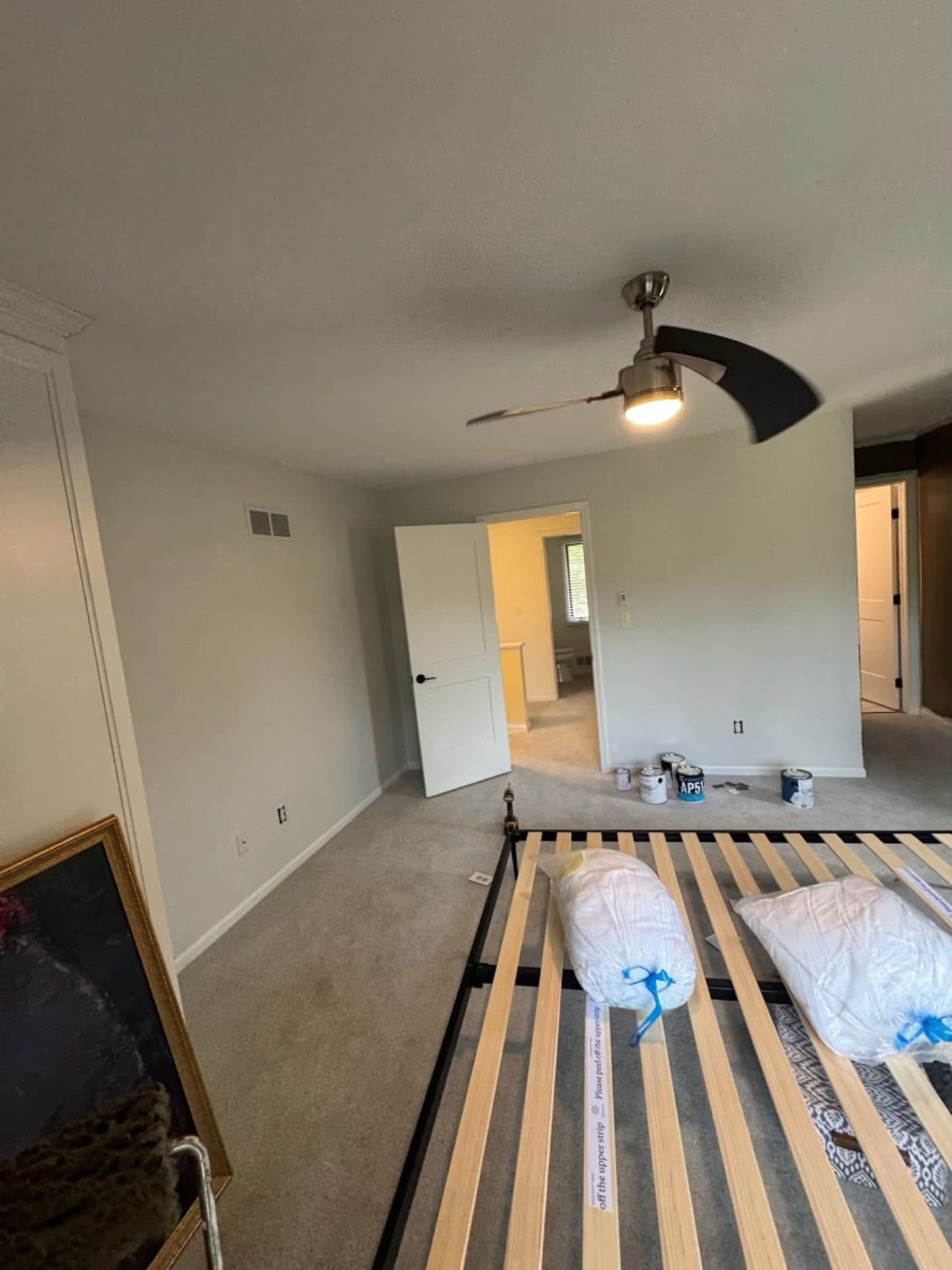 A room prepped for painting with drop protection laid down over the floor