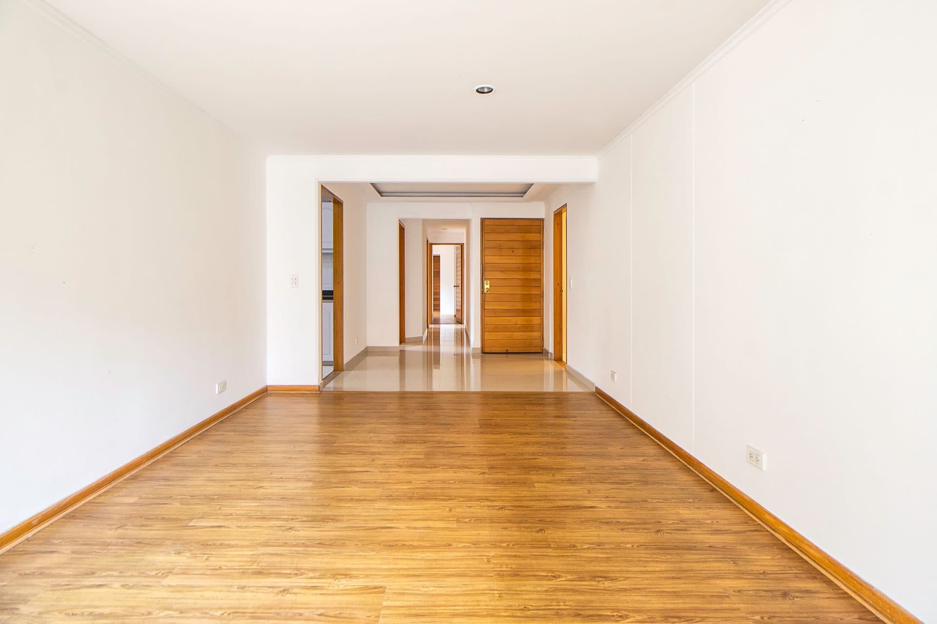A smooth, freshly finished wall in an empty room, primed and ready for paint